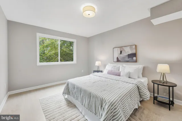 a bedroom with a bed and a night stand