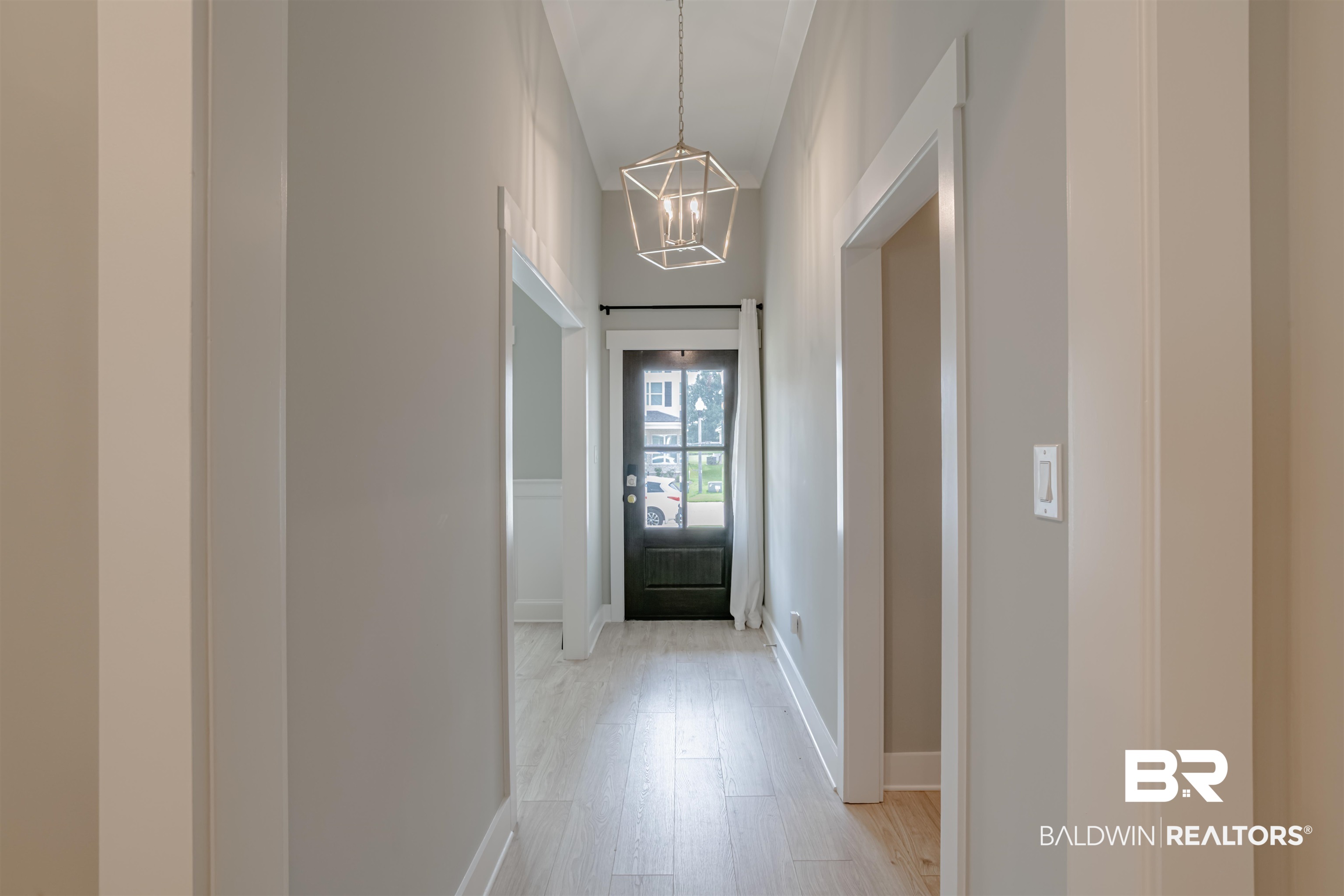655 H Norman Lane Fairhope, AL 36532 - Photo 6 of 30 Doorway to outside with an inviting chandelier and light wood-style flooring