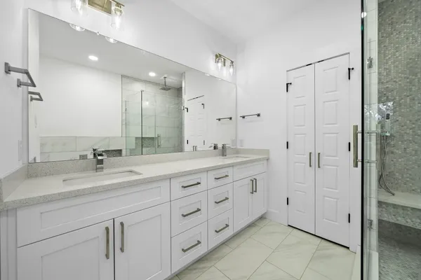 a bathroom with double sink and a mirror
