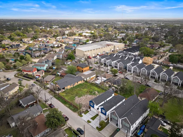 an aerial view of residential building with green space