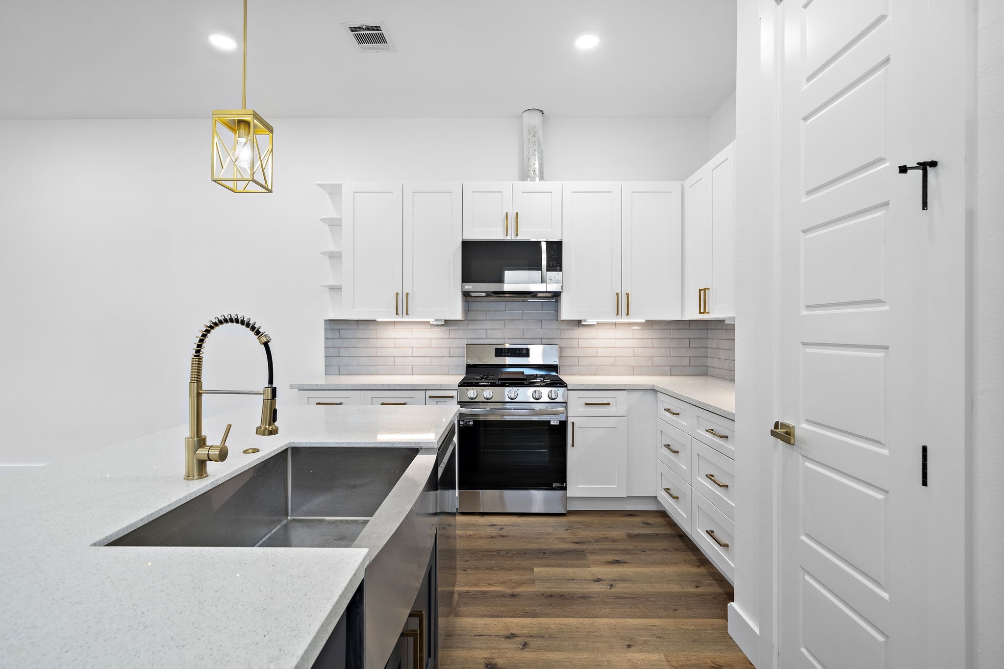 4012 Cetti Street Houston, TX 77009 - Photo 7 of 19 a kitchen with granite countertop a stove a sink and a refrigerator