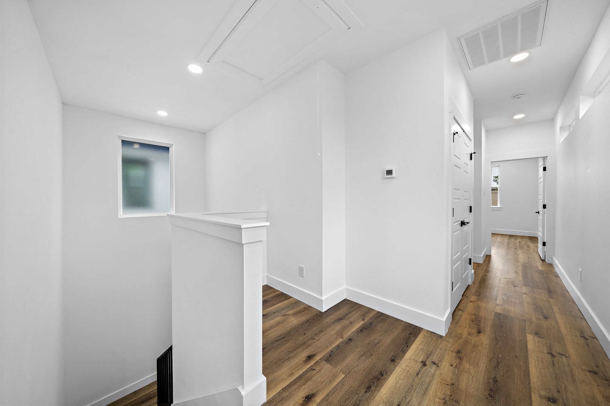 4012 Cetti Street Houston, TX 77009 - Photo 9 of 19 a view of a hallway with wooden floor and a bathroom