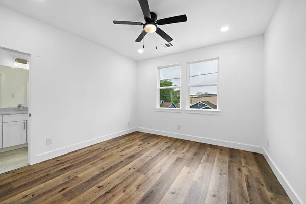 wooden floor in an empty room with a window