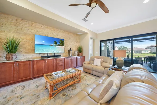 a living room with furniture a flat screen tv and a large window