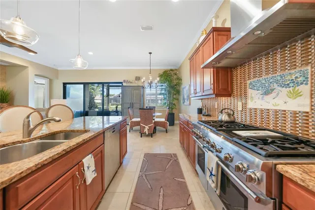 a kitchen with sink stove and cabinets