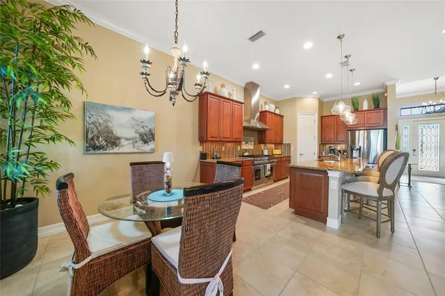 a dining room with granite countertop a table and chairs