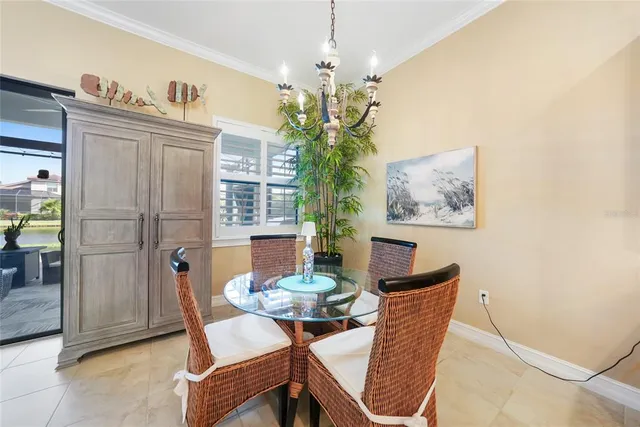 a view of a dining room with furniture and chandelier