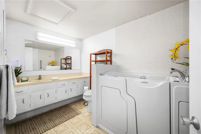 a bathroom with a sink toilet and a mirror
