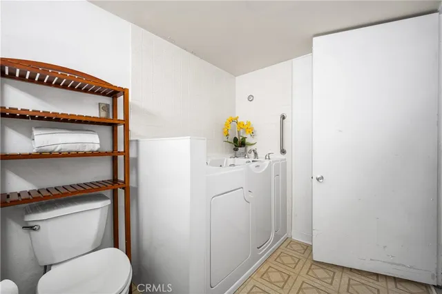 an empty room with mirror and outdoor space