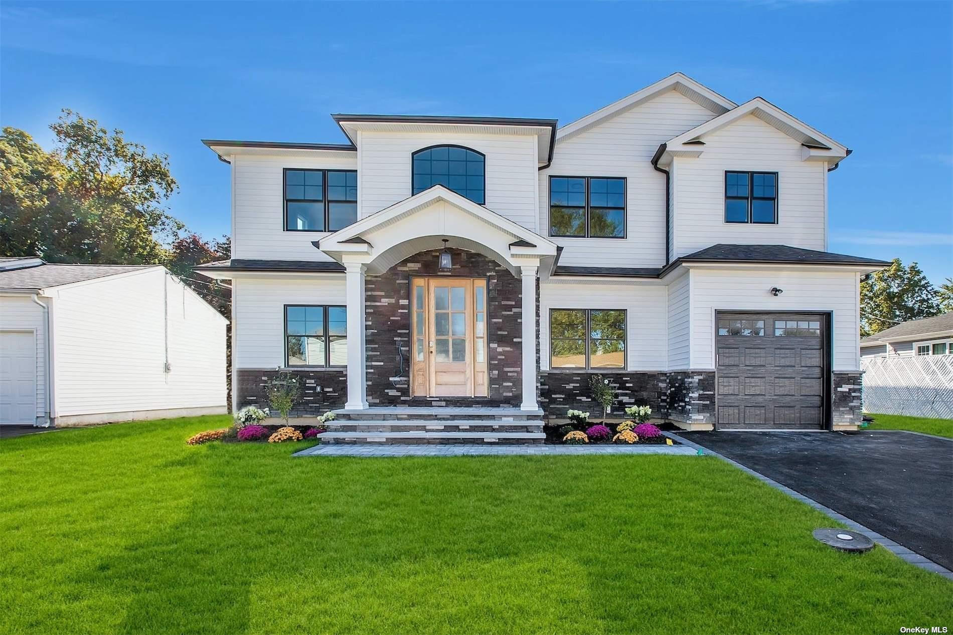 a front view of a house with a garden