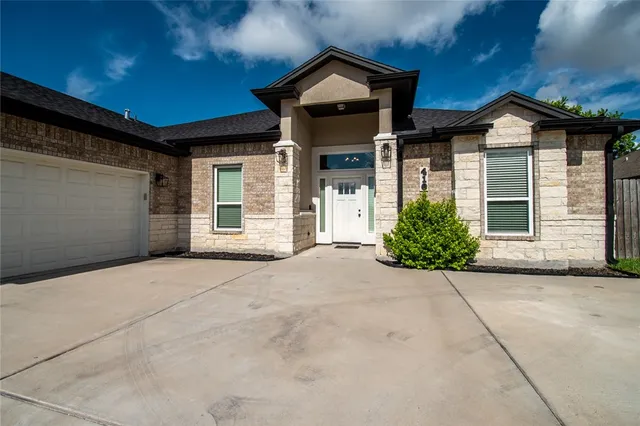 a view of house and garage