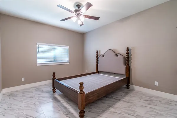 a view of a room with bed and wooden floor