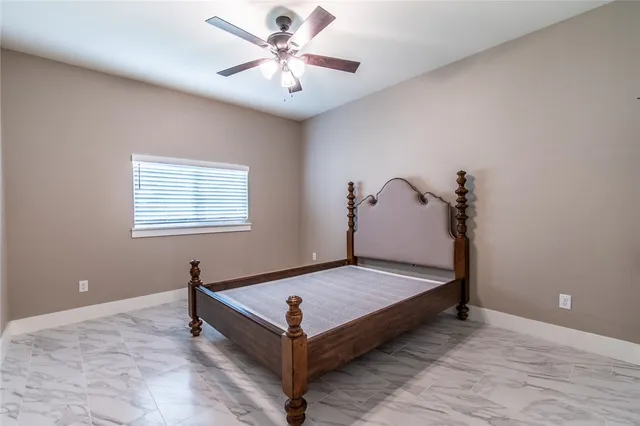 a view of a room with bed and wooden floor