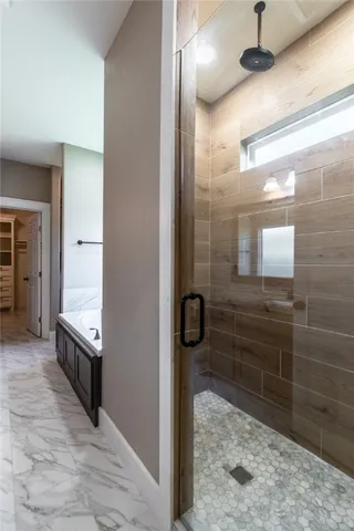a bathroom with a granite countertop double vanity sink and a mirror