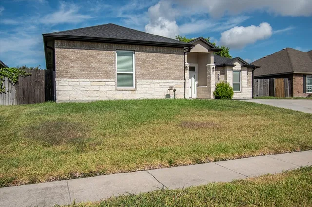 a front view of a house with garden