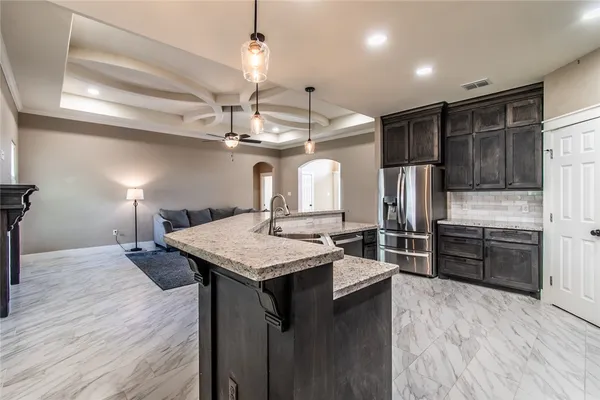 a kitchen with sink refrigerator and window