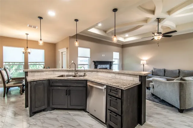 a kitchen with granite countertop a stove microwave and fridge