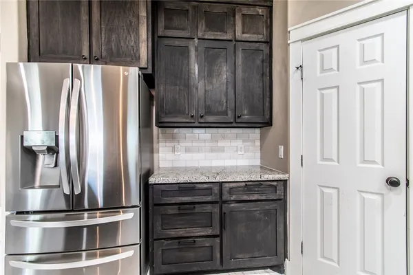 a living room with furniture and kitchen view