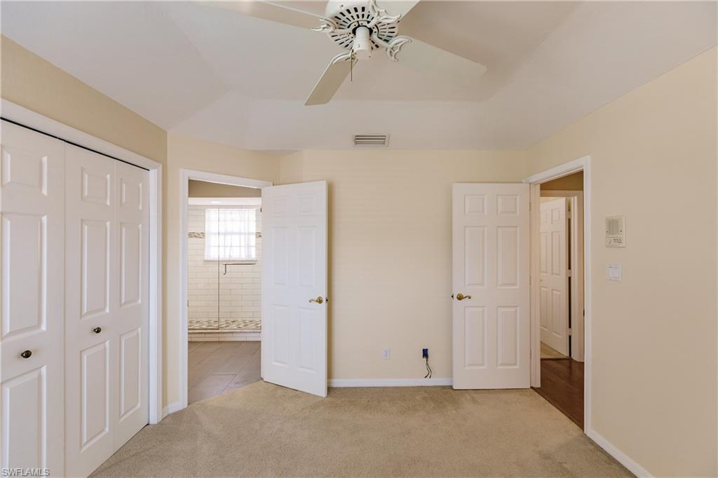 131 Napa Ridge Way Naples, FL 34119 - Photo 27 of 34 an empty room with a ceiling fan and a window