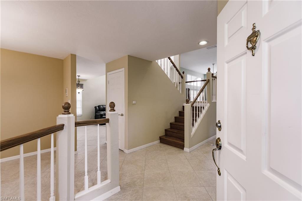 131 Napa Ridge Way Naples, FL 34119 - Photo 3 of 34 a view of a livingroom with stairs and stairs