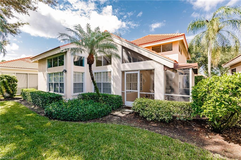 131 Napa Ridge Way Naples, FL 34119 - Photo 34 of 34 a front view of a house with a yard