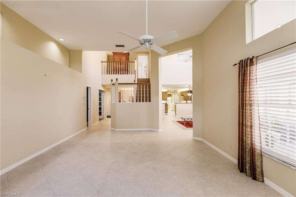 131 Napa Ridge Way Naples, FL 34119 - Photo 8 of 34 a view of empty room with wooden floor and windows