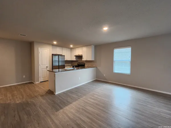 a view of kitchen with wooden floor and electronic appliances