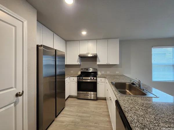 a kitchen with granite countertop stainless steel appliances and granite counter tops