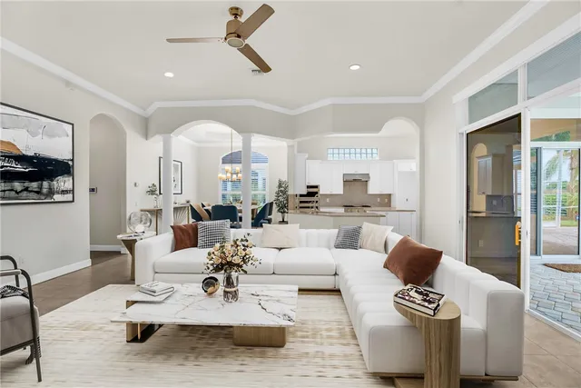 a kitchen with granite countertop a stove a sink and a refrigerator