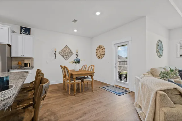 a dining room with furniture and wooden floor