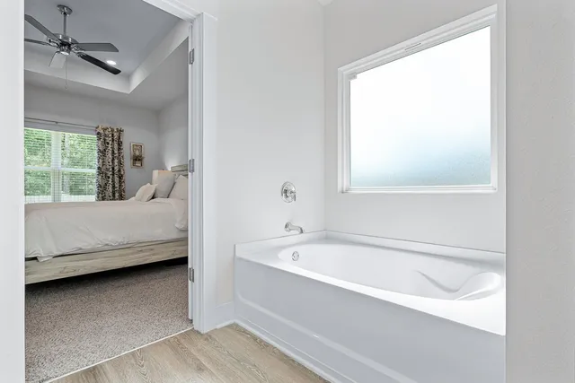 a spacious bedroom with a bed and a chandelier