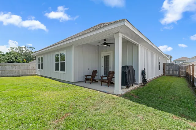 a view of a house with a backyard and a patio
