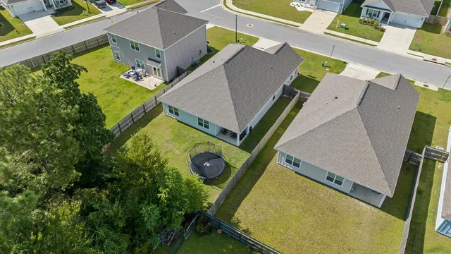 a sign board with a house in the background