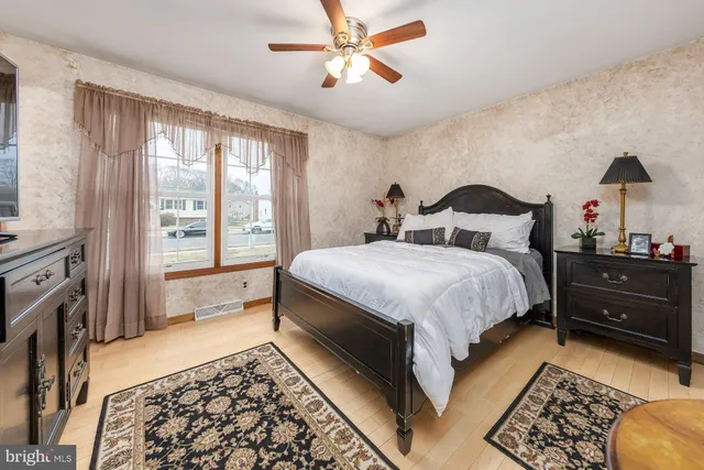 a spacious bedroom with a bed and a chandelier