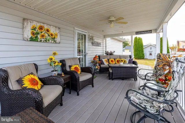 a living room filled with furniture and a floor to ceiling window