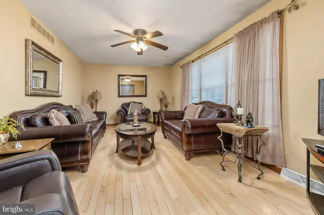 a living room with furniture or couch and a chandelier