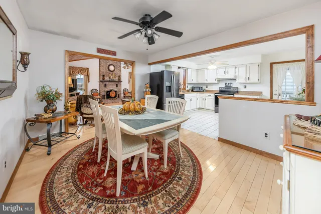 a living room with dining room and couches potted plants