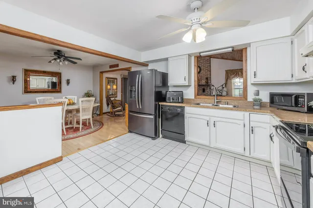 a kitchen with stainless steel appliances a sink and cabinets