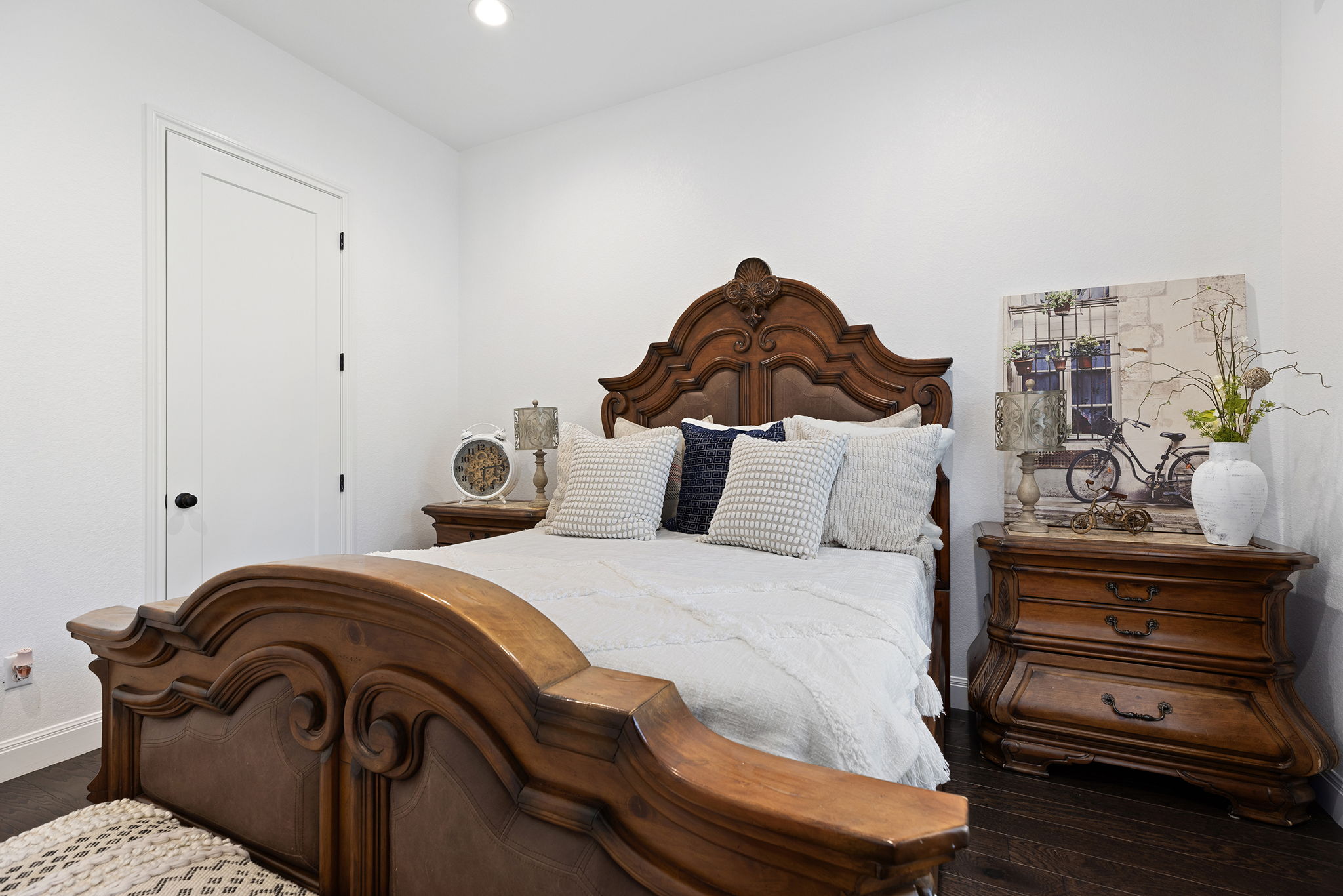 153 Fawn Hollow Elgin, TX 78621 - Photo 27 of 40 a bedroom with a bed and a chandelier