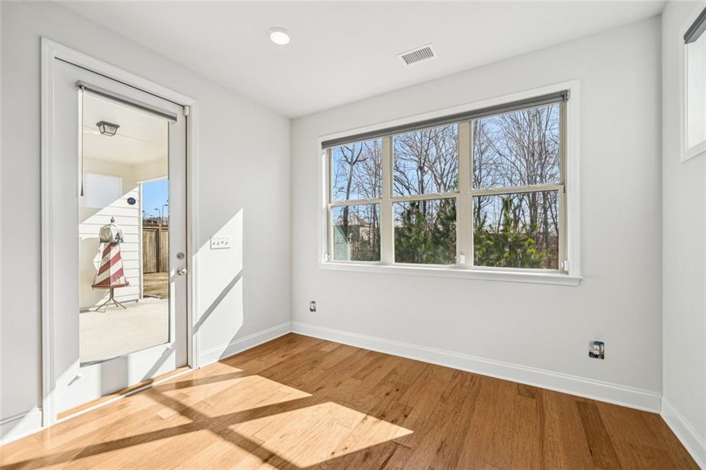 3431 High Shoals Buford, GA 30519 - Photo 16 of 51 a view of empty room with wooden floor and fan