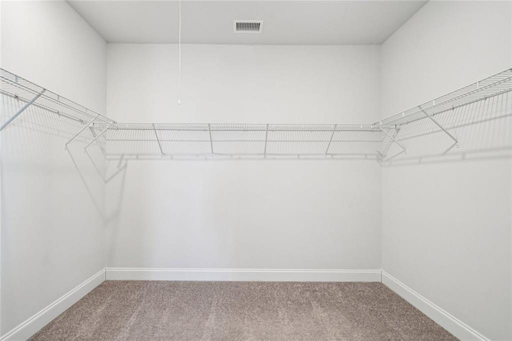 3431 High Shoals Buford, GA 30519 - Photo 19 of 51 a view of a room with racks on the wall