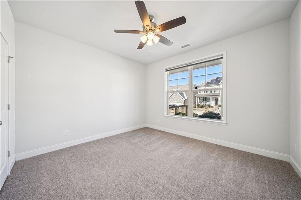 3431 High Shoals Buford, GA 30519 - Photo 21 of 51 an empty room with windows and fan
