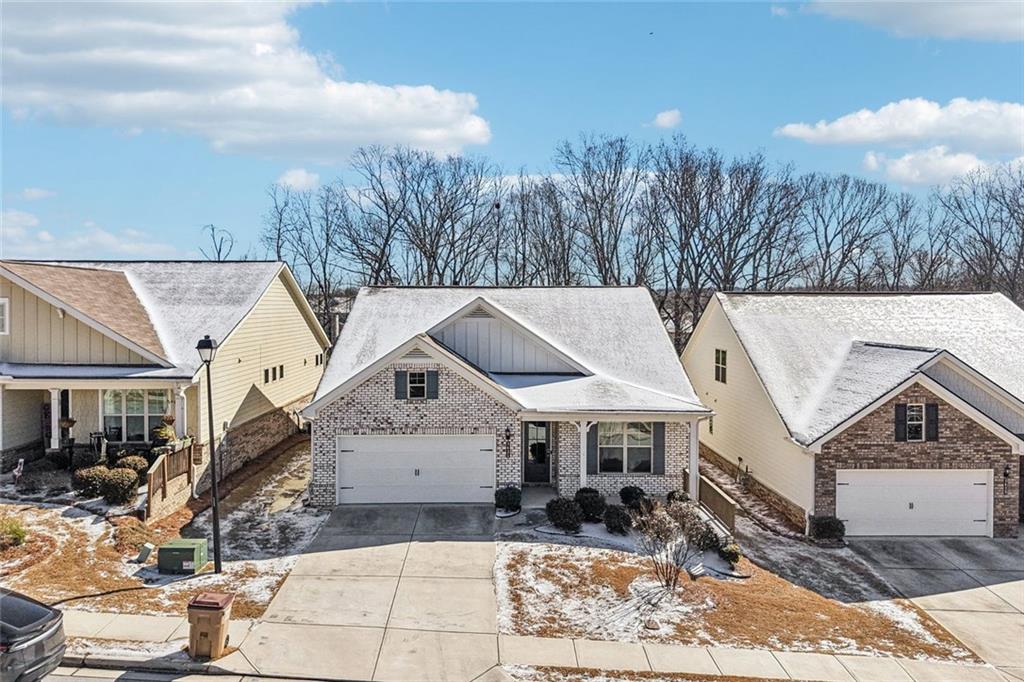3431 High Shoals Buford, GA 30519 - Photo 36 of 51 a view of a white house next to a yard with trees