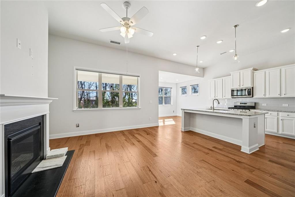3431 High Shoals Buford, GA 30519 - Photo 4 of 51 a large kitchen with cabinets wooden floor and stainless steel appliances