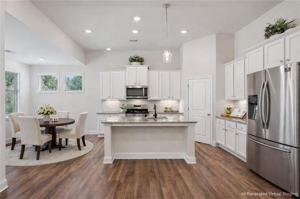 3431 High Shoals Buford, GA 30519 - Photo 8 of 51 a kitchen with stainless steel appliances a microwave a stove a sink dishwasher a refrigerator and white cabinets with wooden floor