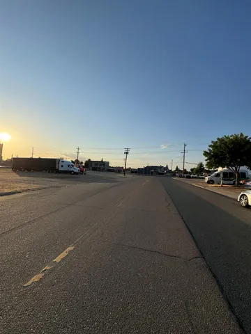 a view of a street with sunset