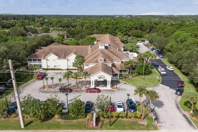 an aerial view of a house with garden space and street view