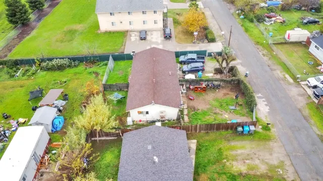 an aerial view of a house with a garden and swimming pool
