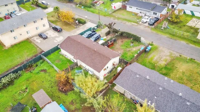 an aerial view of a house with a yard and garden