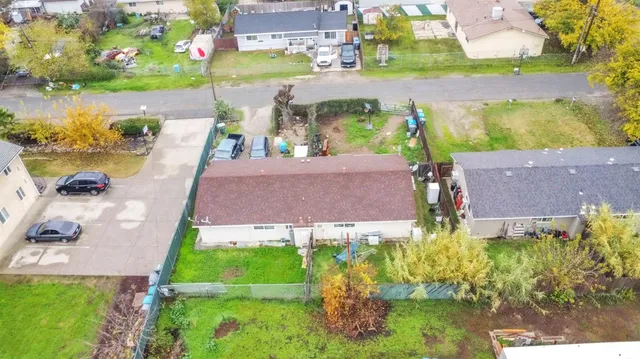 an aerial view of multiple houses with yard